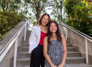 mother and daughter pose on stairs