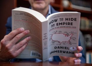dean Cohen holding How to Hide An Empire book