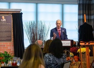 Former president Mote at podium during luncheon