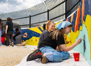 students painting mural